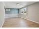 Open-concept living room featuring laminate flooring, neutral paint colors, and plenty of natural light at 4940 Rosedale Ln, Holiday, FL 34690