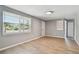 Bright living room with sleek flooring, fresh paint, and ample natural light from a large window at 4940 Rosedale Ln, Holiday, FL 34690