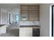 Bright bar area with custom built-in shelving, modern wine fridge and marble backsplash at 501 W Ross Ave # 2, Tampa, FL 33602