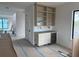 Bright bar area with custom built-in shelving, modern wine fridge and marble backsplash at 501 W Ross Ave # 2, Tampa, FL 33602