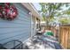 Cozy back porch featuring a chair, a small side table, and a screened-in door leading inside at 5304 Cherry Ave, Seffner, FL 33584