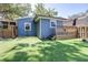 Backyard featuring wooden steps to a porch, a shed, and a tall wooden fence. Artificial turf at 5304 Cherry Ave, Seffner, FL 33584