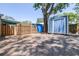 Backyard gravel area leading up to a shed, surrounded by wooden fences and lots of shade at 5304 Cherry Ave, Seffner, FL 33584