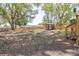 Spacious backyard with wooden fence, large trees, and a small shed, providing privacy and space at 5304 Cherry Ave, Seffner, FL 33584