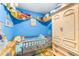 Bright bedroom with blue walls, featuring bed, wardrobe, and toy storage at 5304 Cherry Ave, Seffner, FL 33584