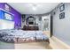 Comfortable bedroom with gray and purple walls featuring walk-in closet and en-suite bathroom at 5304 Cherry Ave, Seffner, FL 33584