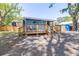 Quaint single-story home features a lovely wooden deck and well-maintained surroundings at 5304 Cherry Ave, Seffner, FL 33584