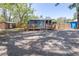 Inviting single-story home with a spacious yard, wooden deck, and decorative wreath on the front at 5304 Cherry Ave, Seffner, FL 33584