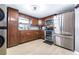 Well-lit kitchen featuring stainless steel appliances, wood cabinets, and tile floors at 5304 Cherry Ave, Seffner, FL 33584