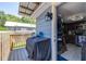 Outdoor kitchen area with a covered grill, stackable washer/dryer, and a cooking space at 5304 Cherry Ave, Seffner, FL 33584