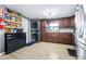 Well-organized kitchen with wood cabinets, stainless appliances and adjacent laundry area at 5304 Cherry Ave, Seffner, FL 33584