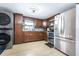 Bright kitchen with stainless steel appliances, wood cabinets, and modern lighting at 5304 Cherry Ave, Seffner, FL 33584