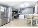 Open-concept space with kitchen and living room featuring tile floors and gray paint at 5304 Cherry Ave, Seffner, FL 33584