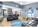Cozy living room featuring hardwood floors, gray walls, and comfortable leather sofas, ideal for relaxation at 5304 Cherry Ave, Seffner, FL 33584