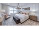 Serene bedroom with a large window, chandelier, and comfortable furnishings at 5727 Silverside Pine Ct, Lakewood Ranch, FL 34211