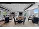 Resident clubhouse with tables and chairs adjacent to a modern kitchen area with bar-style seating, fostering a welcoming social space at 5727 Silverside Pine Ct, Lakewood Ranch, FL 34211