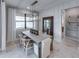 Elegant dining room featuring modern light fixture, large windows, and stylish seating at 5727 Silverside Pine Ct, Lakewood Ranch, FL 34211