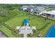 Aerial view of a fenced dog park and playground area complete with walking paths and plenty of room to play at 5727 Silverside Pine Ct, Lakewood Ranch, FL 34211