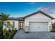 Charming one-story home featuring a two-car garage, stone accents, and well-maintained landscaping at 5727 Silverside Pine Ct, Lakewood Ranch, FL 34211