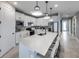 Bright kitchen showcasing a large island with seating, stainless steel appliances and white cabinetry at 5727 Silverside Pine Ct, Lakewood Ranch, FL 34211