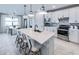 Modern kitchen featuring an island with seating, stainless steel appliances, and ample cabinet space at 5727 Silverside Pine Ct, Lakewood Ranch, FL 34211