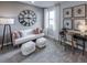 Cozy living room with white couch, large clock, and natural light from the window at 5727 Silverside Pine Ct, Lakewood Ranch, FL 34211