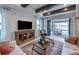 Cozy living room with exposed ceiling beams, comfortable seating, and a view of the outdoor patio at 5727 Silverside Pine Ct, Lakewood Ranch, FL 34211