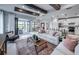 Open-concept living room showcasing a large island, sliding glass doors to the outdoor area, and stylish decor at 5727 Silverside Pine Ct, Lakewood Ranch, FL 34211