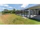 A view of the home's screened-in pool area, large backyard, and lakefront property at 6218 Bridgevista Dr, Lithia, FL 33547