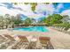 A large community swimming pool with ample lounge chairs for residents to enjoy at 6218 Bridgevista Dr, Lithia, FL 33547