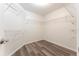 Spacious walk-in closet with built-in shelving and laminate flooring at 6218 Bridgevista Dr, Lithia, FL 33547