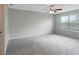 Bright bedroom with large window and ceiling fan at 6306 Tillandsia Pl, Tampa, FL 33610