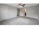 Bedroom with neutral carpet, ceiling fan, and multiple doors at 6306 Tillandsia Pl, Tampa, FL 33610