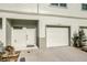 The exterior of a townhouse featuring a garage, entry door, and decorative plants at 6306 Tillandsia Pl, Tampa, FL 33610