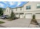 Charming townhouse with an attached garage, driveway, and manicured landscaping at 6306 Tillandsia Pl, Tampa, FL 33610