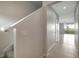 Neutral hallway featuring tile flooring leading to bright living area at 6306 Tillandsia Pl, Tampa, FL 33610