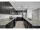 Modern kitchen features granite countertops, stainless steel appliances, and dark wood cabinets at 6306 Tillandsia Pl, Tampa, FL 33610