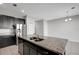 Open kitchen island with stainless steel sink, granite countertops, and ample storage space at 6306 Tillandsia Pl, Tampa, FL 33610