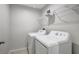 Clean and functional laundry room with washer, dryer, and convenient shelving at 6306 Tillandsia Pl, Tampa, FL 33610