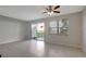 Spacious living room with tile flooring, sliding glass door to patio, and natural light at 6306 Tillandsia Pl, Tampa, FL 33610