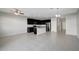 Open concept living area with tile floors and modern kitchen featuring an island with stainless steel sink at 6306 Tillandsia Pl, Tampa, FL 33610