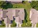 An aerial shot highlights the roof and landscaping details of the property within its neighborhood at 6514 Thicket Trl, New Port Richey, FL 34653