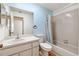 A bathroom showcasing a bathtub, toilet, vanity and mirror with blue accent wall at 6514 Thicket Trl, New Port Richey, FL 34653