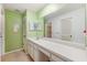 Bathroom features a large vanity, mirrors, storage, and separate toilet and shower area at 6514 Thicket Trl, New Port Richey, FL 34653