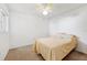 Neutral bedroom with a ceiling fan, carpet, and a bed with yellow covers and pillows at 6514 Thicket Trl, New Port Richey, FL 34653