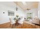 Dining area with modern chairs and a living room area in the background at 6514 Thicket Trl, New Port Richey, FL 34653