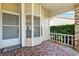 Covered front porch with patterned tile and view of the lawn at 6514 Thicket Trl, New Port Richey, FL 34653