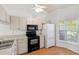 White kitchen featuring stainless steel sink and modern appliances at 6514 Thicket Trl, New Port Richey, FL 34653