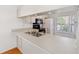 White kitchen featuring stainless steel sink and modern appliances at 6514 Thicket Trl, New Port Richey, FL 34653
