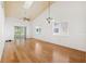 Bright living room with vaulted ceilings, skylight, ceiling fan, and light hardwood floors at 6514 Thicket Trl, New Port Richey, FL 34653